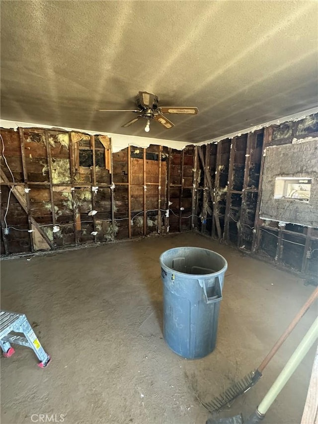 interior space with ceiling fan