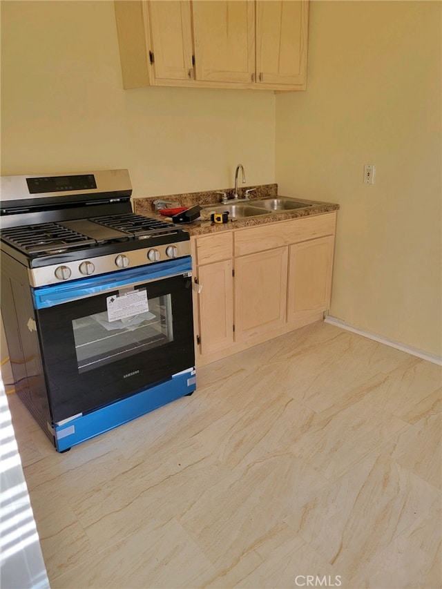 kitchen featuring gas range oven and sink