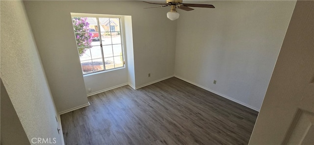 unfurnished room with ceiling fan and dark hardwood / wood-style floors