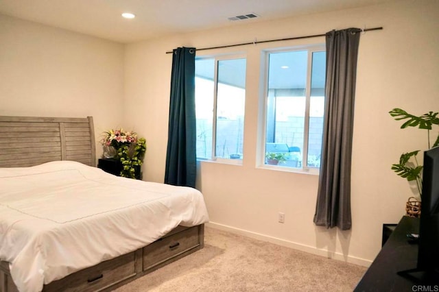 bedroom featuring light carpet