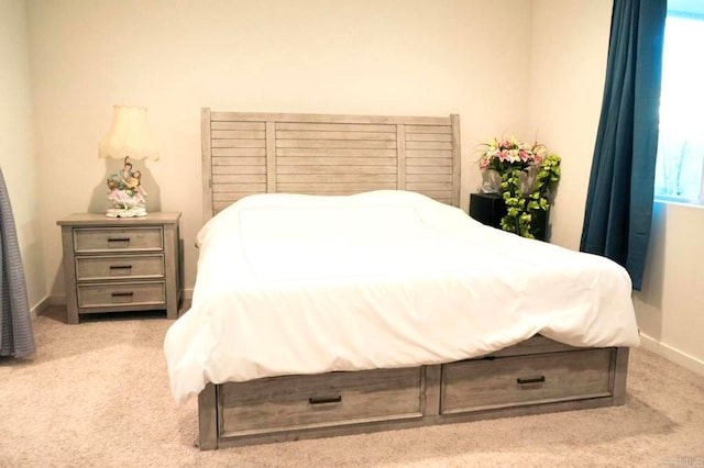 bedroom featuring light colored carpet