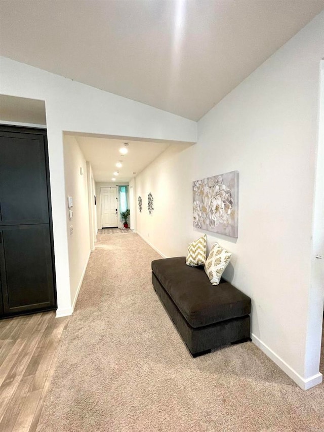 sitting room with vaulted ceiling and hardwood / wood-style floors