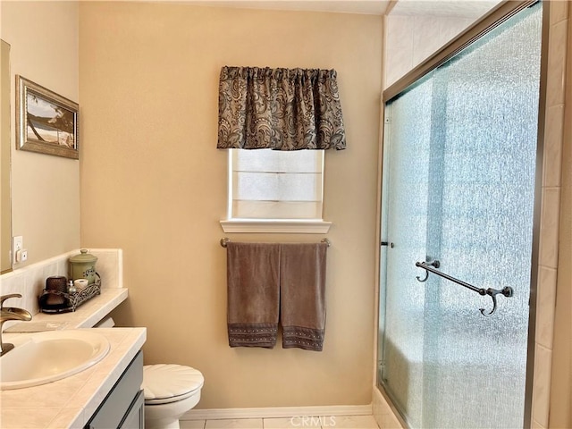 bathroom with toilet, vanity, tile patterned floors, and a shower with shower door