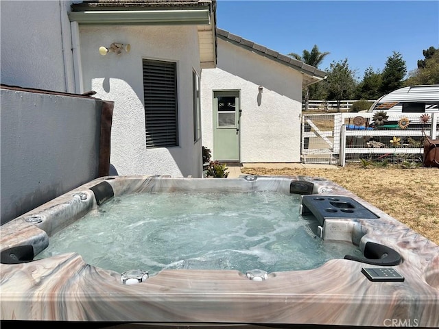 view of patio / terrace with a hot tub