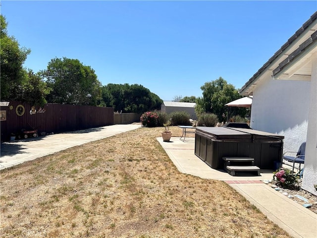 view of yard with a patio and a hot tub