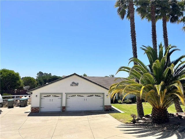 view of front of property with a garage and a front yard