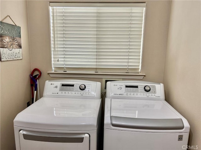 clothes washing area featuring washer and dryer