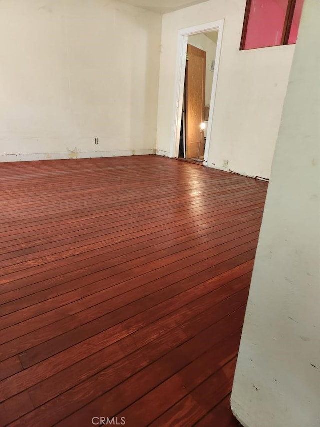 empty room with dark hardwood / wood-style floors