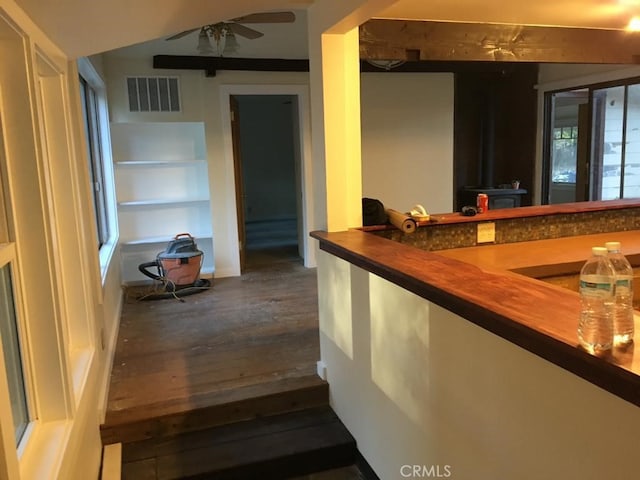 bar featuring wood-type flooring and ceiling fan