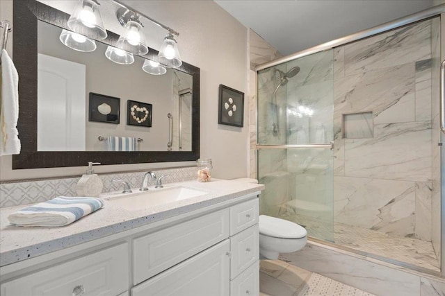 bathroom featuring vanity, toilet, and walk in shower