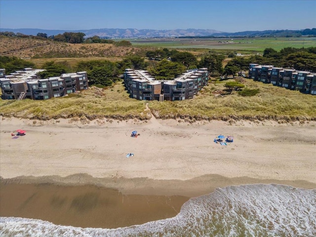 drone / aerial view with a water and mountain view