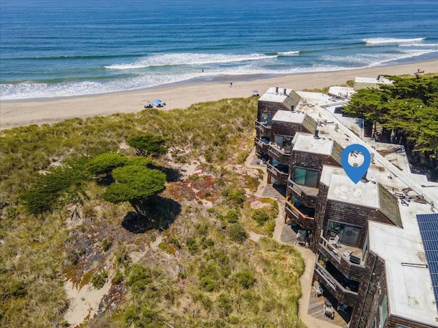 birds eye view of property featuring a water view and a beach view