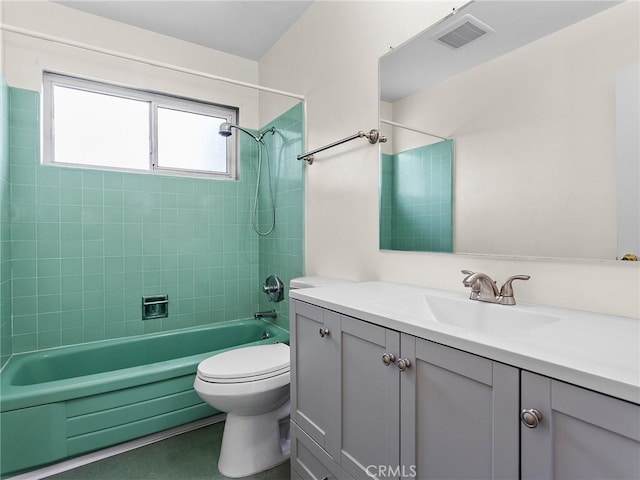 full bathroom featuring toilet, vanity, and tiled shower / bath