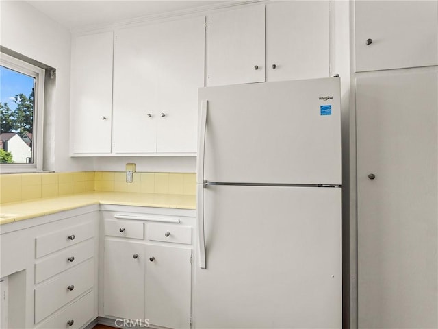 kitchen with white cabinets and white refrigerator