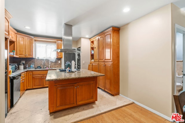 kitchen featuring a center island, light stone countertops, light hardwood / wood-style floors, island range hood, and stainless steel appliances