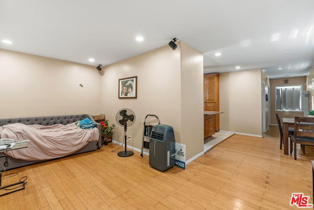 bedroom featuring light hardwood / wood-style floors and ensuite bathroom