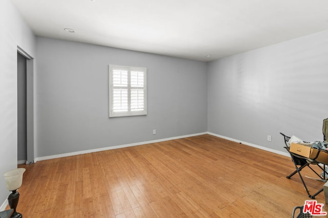 spare room with hardwood / wood-style flooring