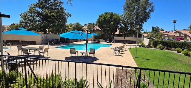 view of swimming pool with a yard and a patio