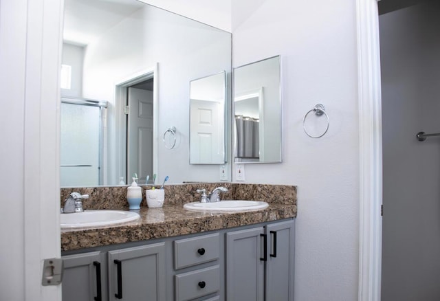 bathroom with vanity and a shower with shower door