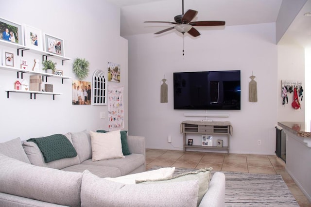 living room featuring ceiling fan, light tile patterned flooring, and high vaulted ceiling