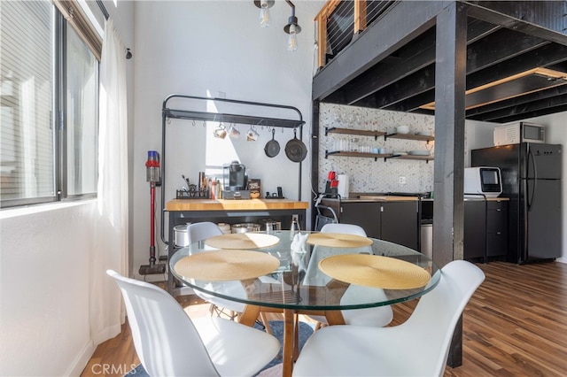 dining room featuring dark hardwood / wood-style floors and bar area