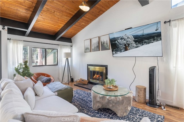 living room with wood-type flooring, wood ceiling, lofted ceiling with beams, and a healthy amount of sunlight