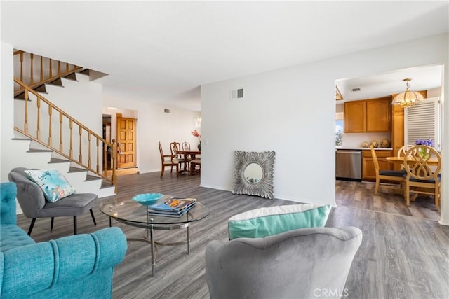 living room featuring an inviting chandelier and hardwood / wood-style flooring