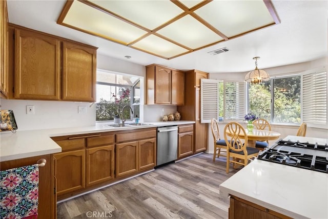 kitchen featuring pendant lighting, dishwasher, a healthy amount of sunlight, and sink