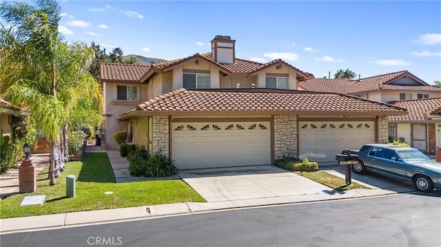 mediterranean / spanish house featuring a front lawn and a garage