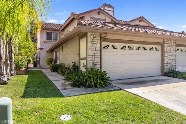 view of front of house with a front yard and a garage