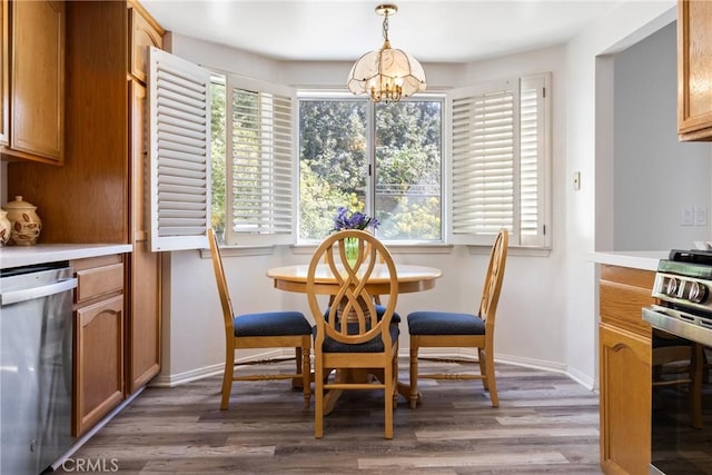 dining area with hardwood / wood-style floors and a notable chandelier