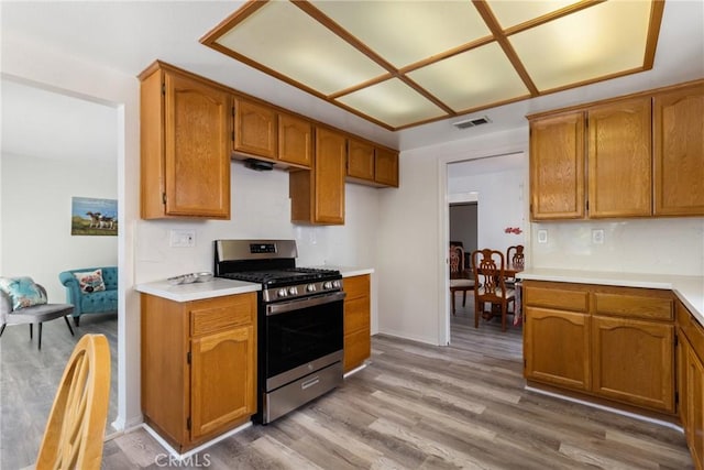 kitchen with light hardwood / wood-style floors and stainless steel gas range