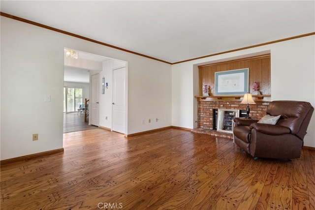 living room featuring a fireplace, hardwood / wood-style floors, and ornamental molding