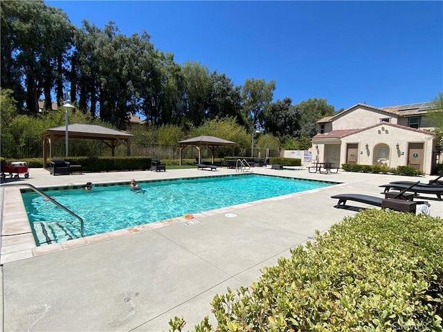 view of swimming pool featuring a gazebo and a patio