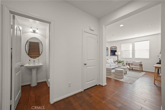 hall featuring dark hardwood / wood-style flooring and sink