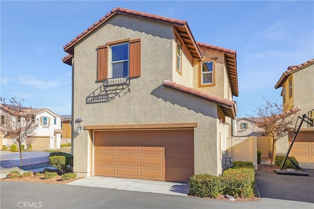 mediterranean / spanish-style home with a garage