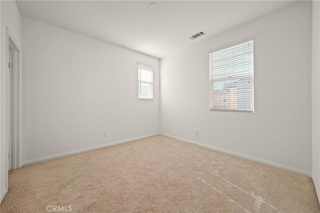 unfurnished room with light carpet