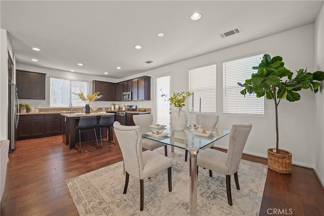 dining area featuring dark wood-type flooring