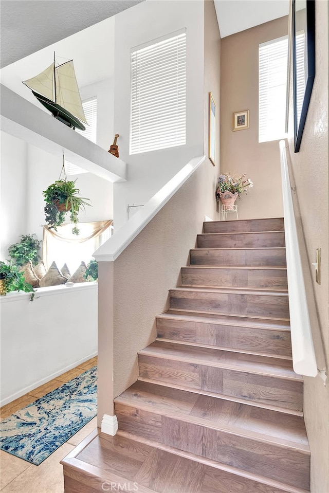 stairs featuring hardwood / wood-style floors