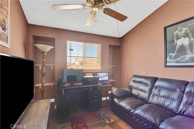 home office with vaulted ceiling, ceiling fan, and hardwood / wood-style flooring