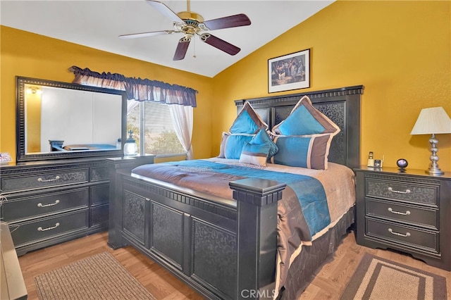 bedroom featuring vaulted ceiling, ceiling fan, and light hardwood / wood-style flooring