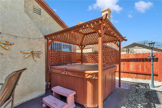 view of patio with a hot tub