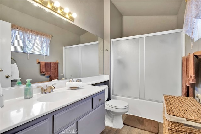 full bathroom featuring vanity, lofted ceiling, toilet, bath / shower combo with glass door, and hardwood / wood-style floors