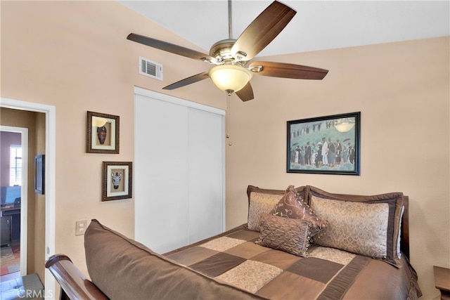 bedroom featuring vaulted ceiling, ceiling fan, and a closet