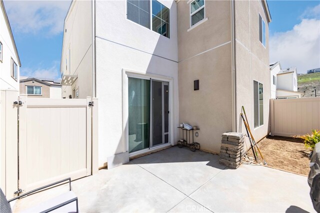 entrance to property with a patio