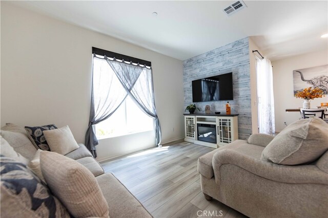 living room with a fireplace and light hardwood / wood-style floors