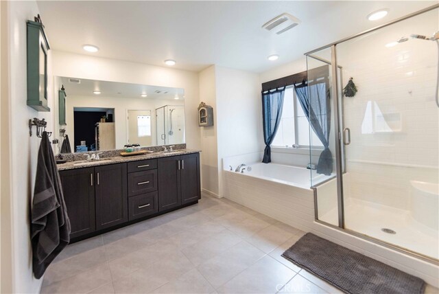 bathroom with plus walk in shower, tile patterned floors, and vanity