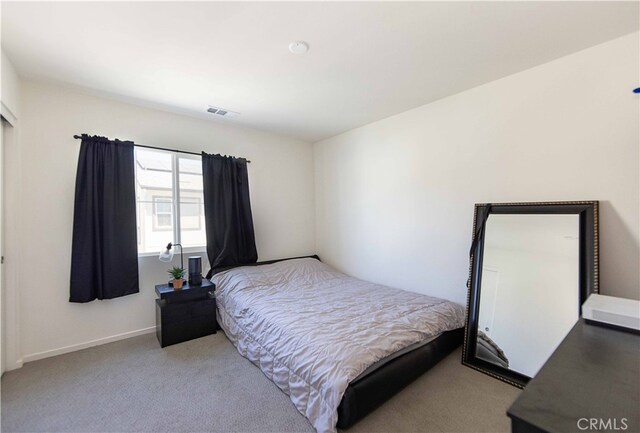 bedroom featuring light colored carpet