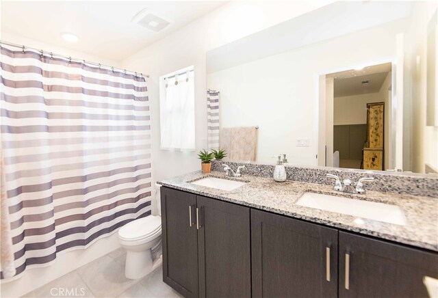 full bathroom with shower / tub combo, tile patterned flooring, vanity, and toilet