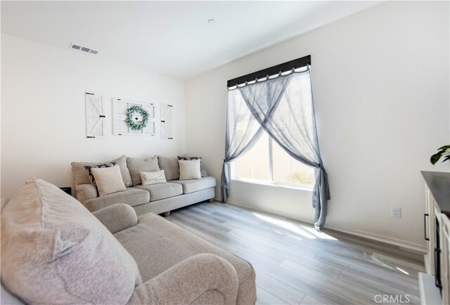 living room with light hardwood / wood-style floors